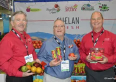 Jay Dyer, Michael Nickoloff and Mac Riggan with Chelan Fresh Marketing. Jay shows a holiday fruit bag while Michael and Mac show Rockit apples in different packaging.